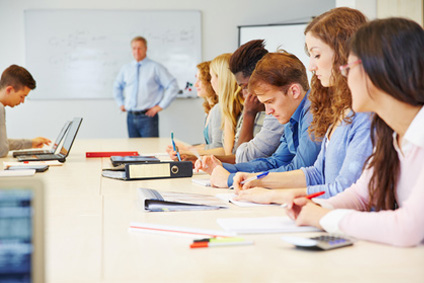 Teilnehmer in einer IT-Schulung an Laptops